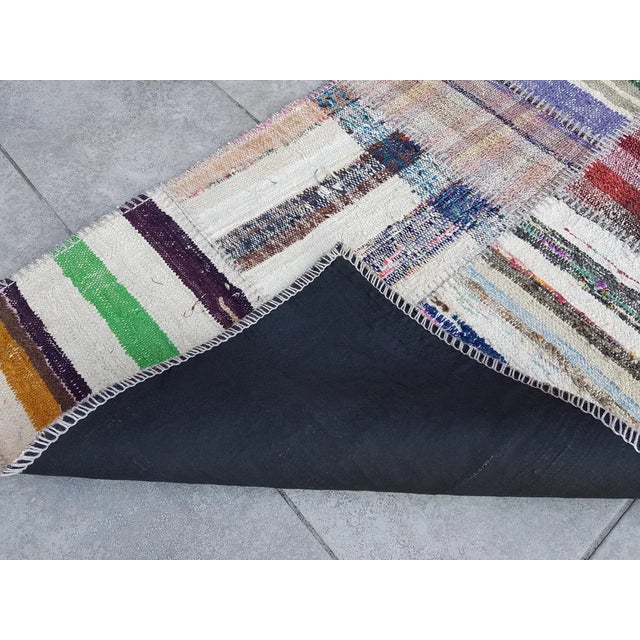 This is a vintage Turkish Oushak rug from the Mid 20th Century. The piece was hand-knotted.