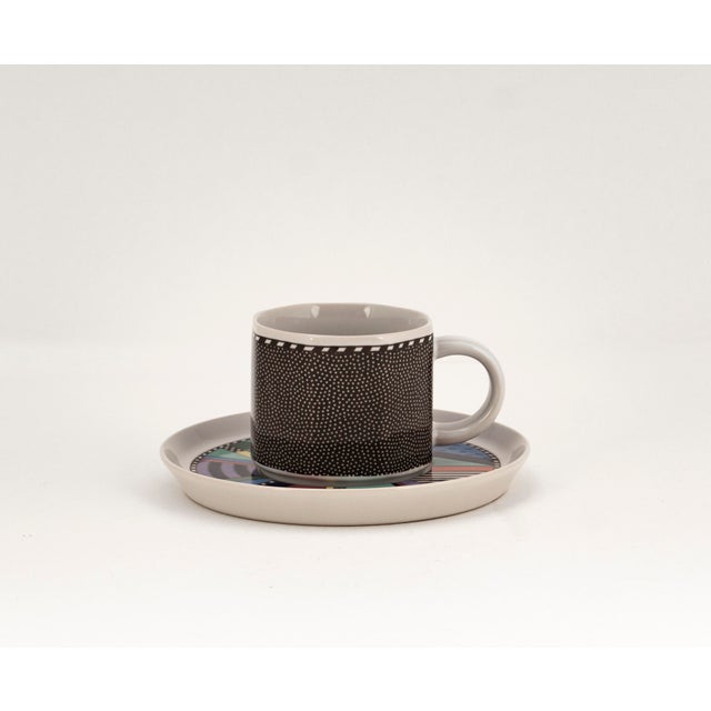 An elegant tea and coffee cup with matching saucer from the iconic "Scenario Metropol" porcelain collection, designed by...
