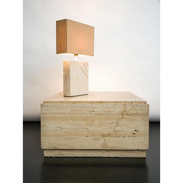 1970s travertine table lamp with rectangular lampshade. The textured shade blends perfectly with the beige stone. A piece...