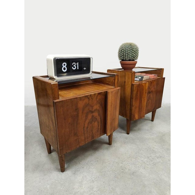 Two of a kind! These beautiful Italian mid-century design bedside tables are a feast for the eyes. Period: 1930. Crafted...