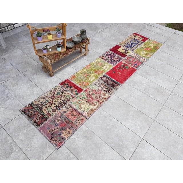 This is a vintage Turkish Oushak rug from the Mid 20th Century. The piece was hand-knotted.