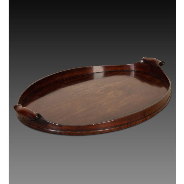 18th century george iii mahogany oval tray, with ebony line inlay to the rim and a pair of scroll handles, centred with a...