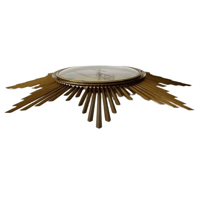 Beautiful, original mid-century ‘sunburst’ wall clock by the renowned German brand Junghans (model ATO-MAT electronic). An...