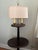 2 tier with brass gallery railing accents, push button switch, linen shade with finial, pedestal base with large brass...