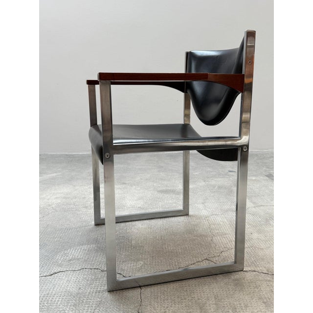 Fantastic, very exclusive, and rare set of two conference chairs with a solid, chrome-plated steel frame and black leather...
