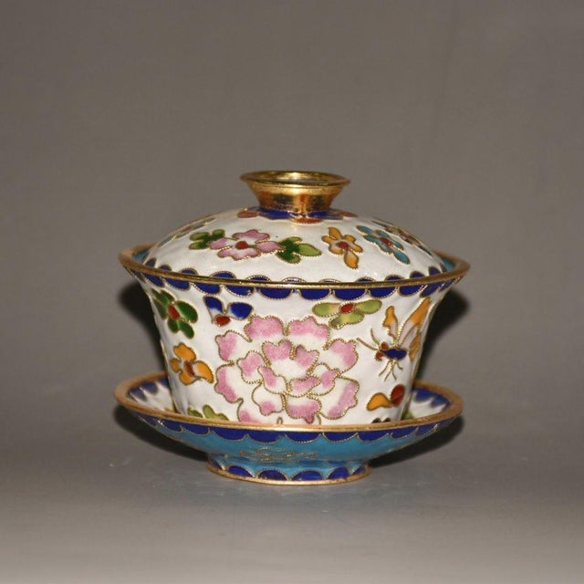 This elegant Chinese gaiwan tea set is crafted with copper base and fine cloisonne wire enamel work. Bright peony blooms...