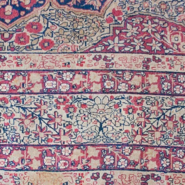 A late 19th century Persian Kermanshah rug with beautiful central medallion with all-over floral pattern, surrounded by a...