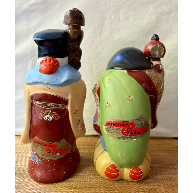 This unique and colorful pair of vintage sake decanters were produced in mid-century Japan for the Kamotsuru Sake company...