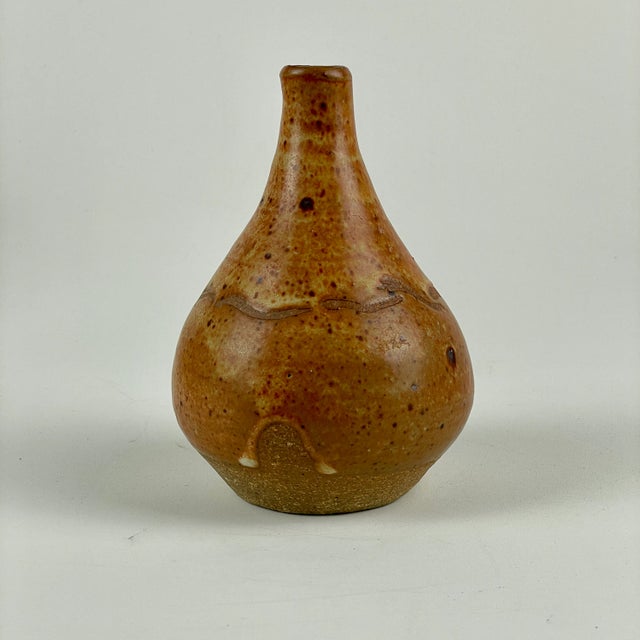 A Little Vintage & Signed Volcanic Shaped Bud Vase In Lively Earth Tone Orange. This is one of those pieces that continues...