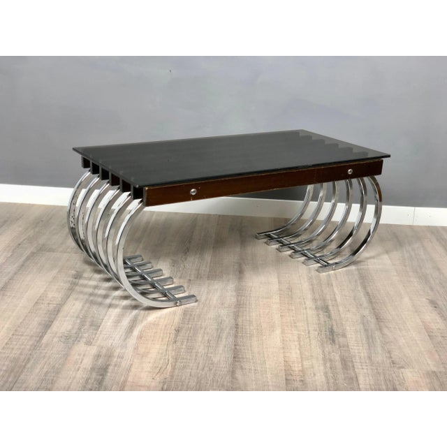 Amazing side or coffee table with curved chrome legs and the base of the table is made of wooden beams on which the smoked...