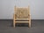 A distinctive french lounge chair from the 1970s, combining a beautifully turned wooden frame with an intricately woven...