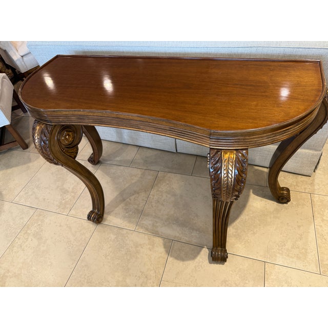 Mahogany and Gilt Chatsworth Console Table, the finish is a wonderful warm brown mahogany with gilt accents. This table...