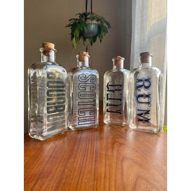 Set of four liquor decanters with fantastic typography, circa 1970s. Alphagraphic statement pieces for a Modernist home.