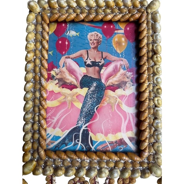 Vintage handmade sailor’s valentine style shell-art wall hanging featuring an image of Bette Midler as her iconic mermaid...