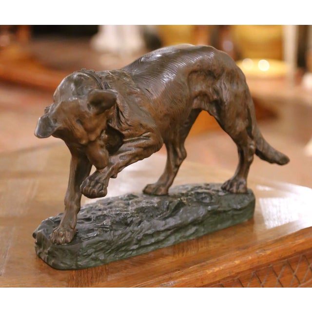 This finely cast antique French animalier bronze, circa 1910, depicts a powerful hunting dog captured mid-stride, head...
