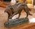 This finely cast antique French animalier bronze, circa 1910, depicts a powerful hunting dog captured mid-stride, head...