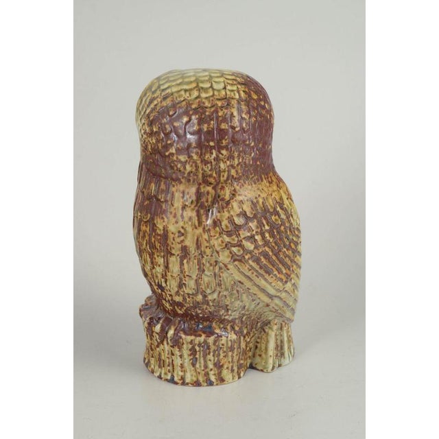 Sven Wejsfelt for Gustavsberg, owl figure. Naturalistic owl figure in stoneware with detailed relief and a vibrant,...