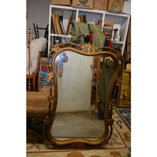 This is a good looking mirror. Great over a mantel. Not sure of the material, but it is quite solid, probably composite....