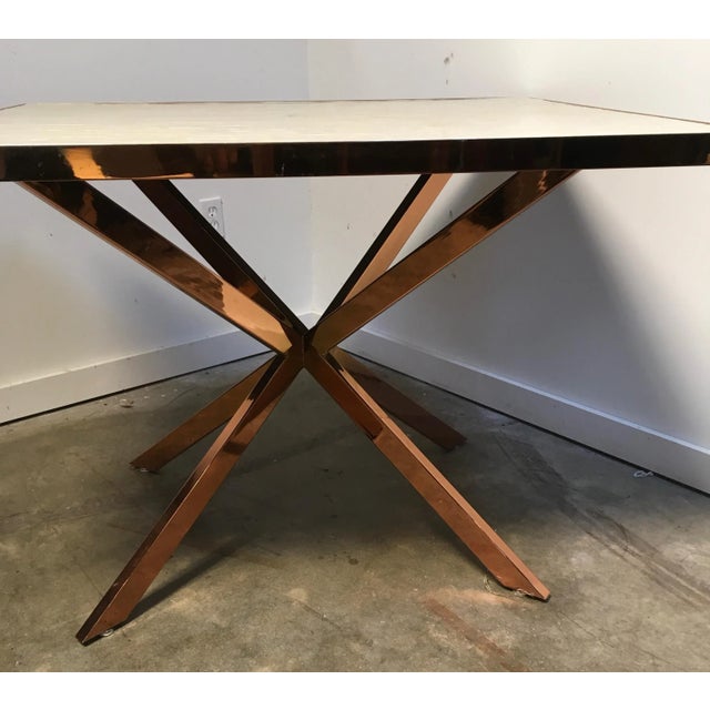 Striking accent table in the manner of Karl Springer. Square tube, rose gold plated frame with faux capiz shell laminate...