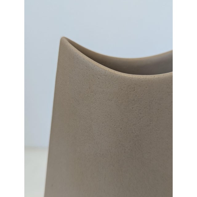 A late-century ceramic vase from Evangeline Pottery (L’Abelle), Quebec, featuring the studio’s signature crescent-mouth...