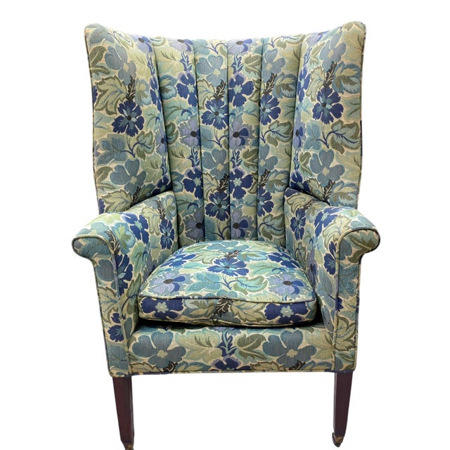 This Early 20th Century English wingback chair in the Edwardian Tradition is a visually engaging and very distinguished...
