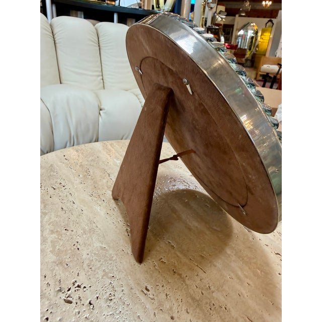 Elegant vintage Italian oval picture frame crafted in silver-plated metal, featuring a polished surface and a sculptural...