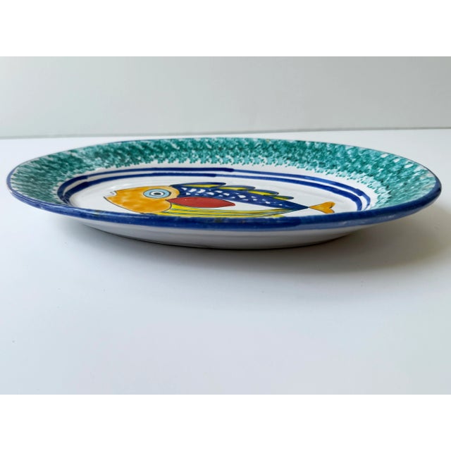 A plate to take you to the sunny Sicilian shores. This colorful platter features a fish in orange, red, yellow, turquoise...