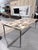 A bold and artistic dining table from Interlude Home that captures the spirit of Mid-Century Modern design through...