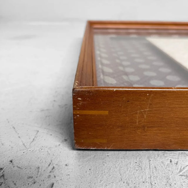 Decorative Japanese hand-painted calligraphy, floating mounted on a textile background. Translation: "Longevity is like a...