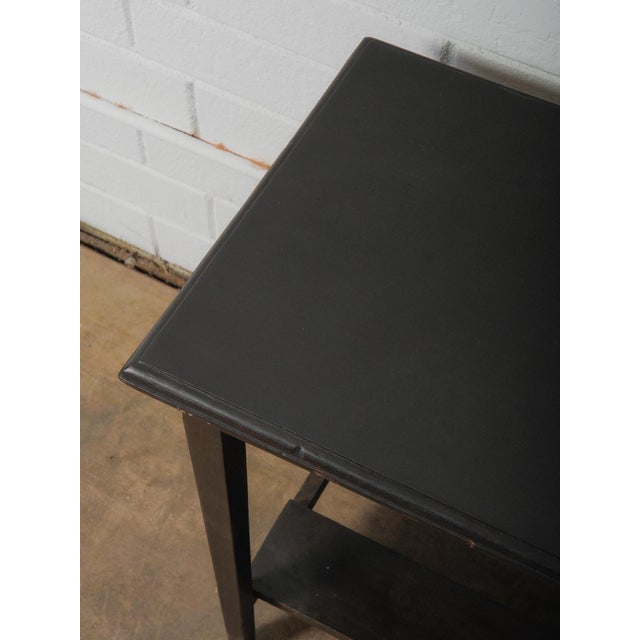A study in quiet proportion and understated presence, this dark wooden side table offers a grounded, architectural...