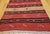 This striking vintage Turkish kilim runner, handwoven in Anatolia during the mid-20th century, embodies the artistry and...