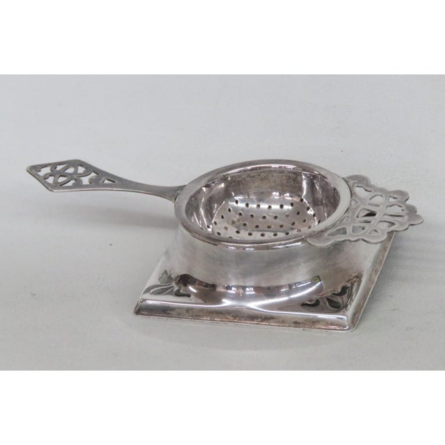 This beautiful Tea Strainer is made of metal and silver plated. This lovely silver tone piece is marked on the back with...