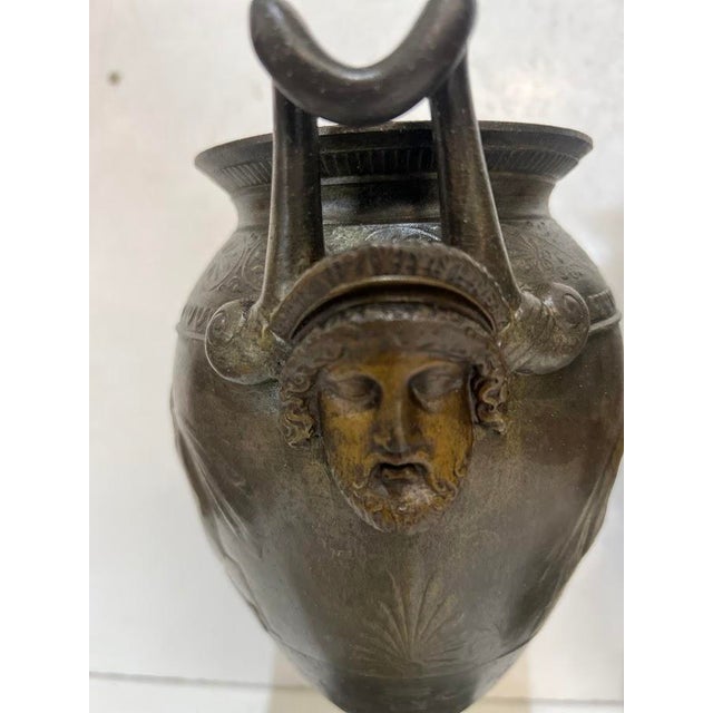 A lovely pair of vases decorated in the antique style. spelter with a brown patina. round green marble base. good...