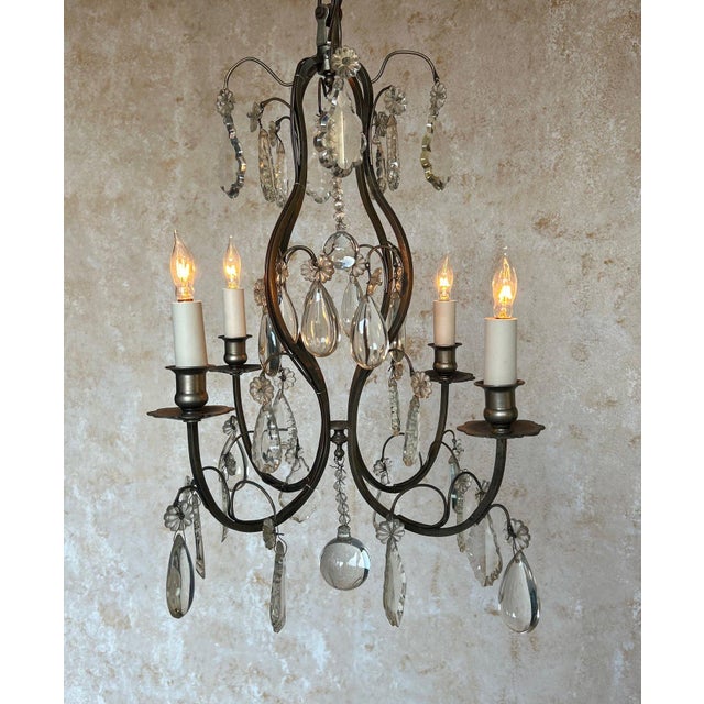 This charming French chandelier, circa 1940s, features a silvered metal structure with four arms, wired for candelabra...