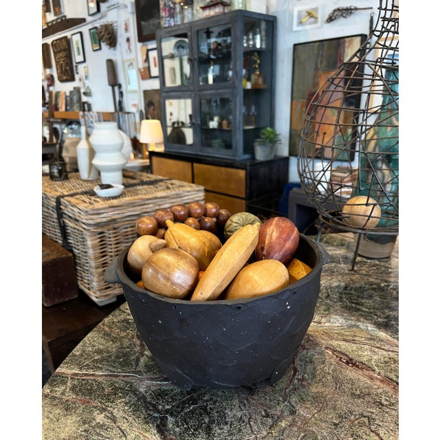 This is a dark brown hand-formed ceramic pot with a matte finish, unglazed. The pot features two small handles on either...