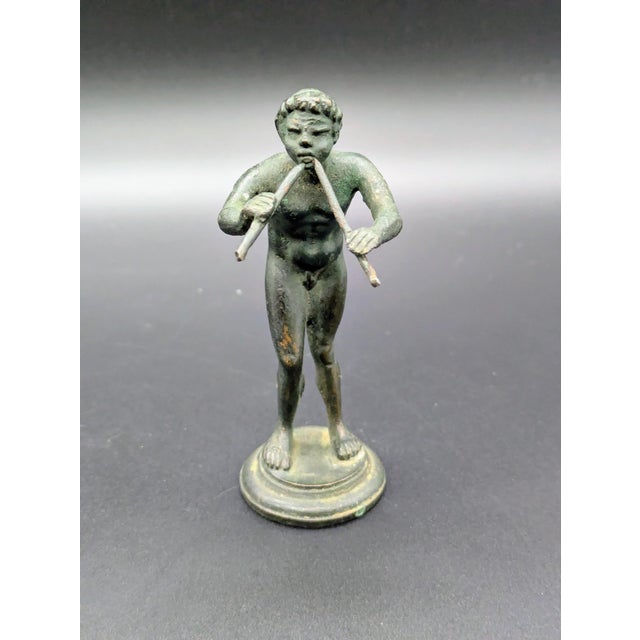 Traveling Man Treasures is selling this patinated bronze statuette depicting a Faun/Satyr playing a double flute (also...