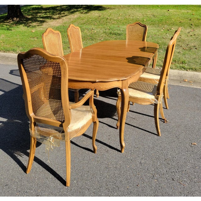 1960s Thomasville French Provincial Walnut Extension Dining Table and six chairs. Notable design features include...