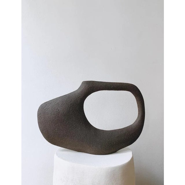 Jon Tribu 5.23 sculpture by Léontine Furcy Unique piece. Materials: Raw black sandstone. Dimensions: L 34 x H 23 cm....