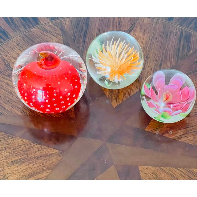3 vintage glass paparweights- 2 floral and one with controlled bubbles.