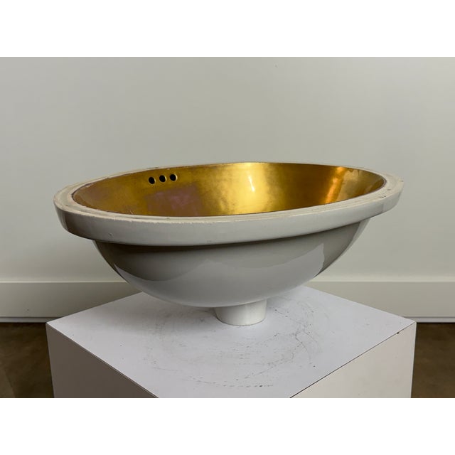 Vintage Sherle Wagner Italian porcelain undermount lavatory sink featuring a crisp white glazed exterior and a striking...