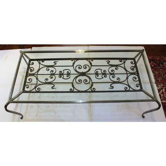 Mid-19th century & later Polished French Steel & Glass Coffee Table. Created around an antique iron panel, the motifs of...