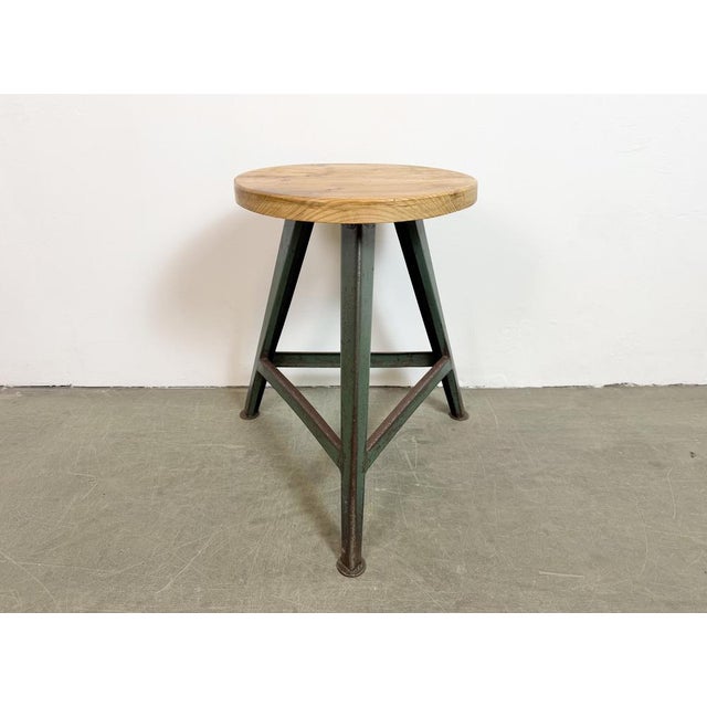 Vintage Industrial factory stool made in former Czechoslovakia during the 1960s It features a wooden seat and a green...