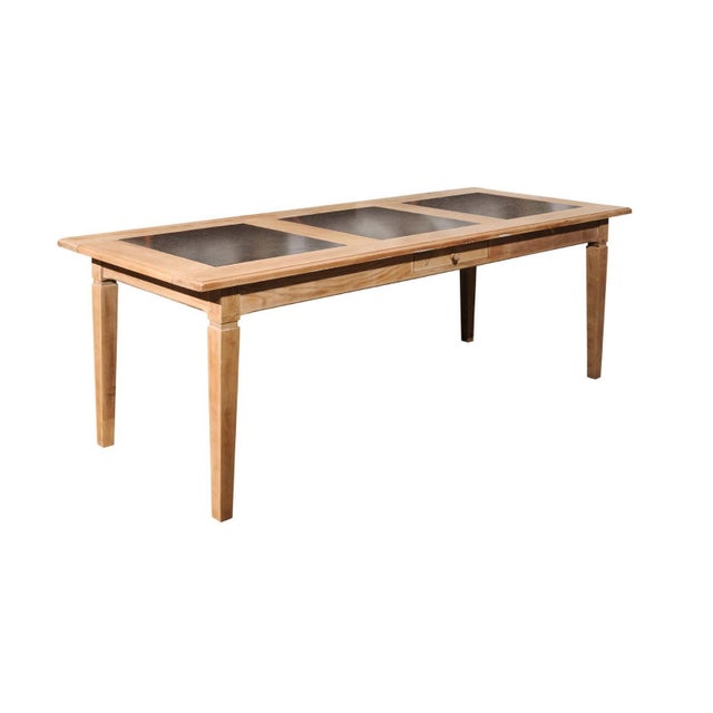 A Southern French Midcentury natural oak dining table with black fossil marble top and tapered legs. This Southern French...