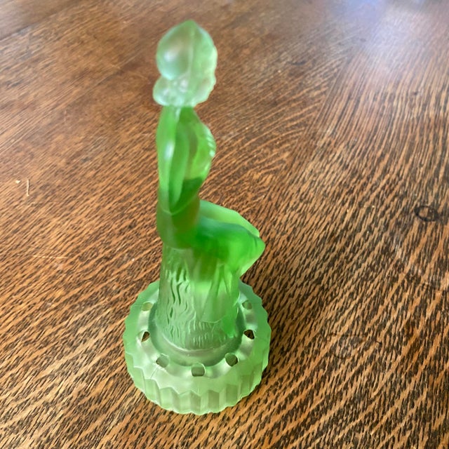 Figure of a lady made of green glass (Uranium Glass). Set out for decor or use as a flower frog in a bowl or vase. Czech...