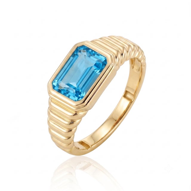 Capture the vivid glow of clear skies with this vibrant statement ring. Showcasing a natural Swiss Blue Topaz gemstone in...