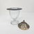 This Potpourri Holder is a decorative vessel, composed of a clear, footed glass base with etched or cut glass detailing...