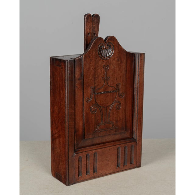 An early 19th century French fariniere, made of walnut with nicely detailed hand-carved shell and incised urn. Good...
