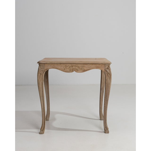 Executed in warm, golden oak with the graceful sensibility of the Louis XV period, this early twentieth-century French...