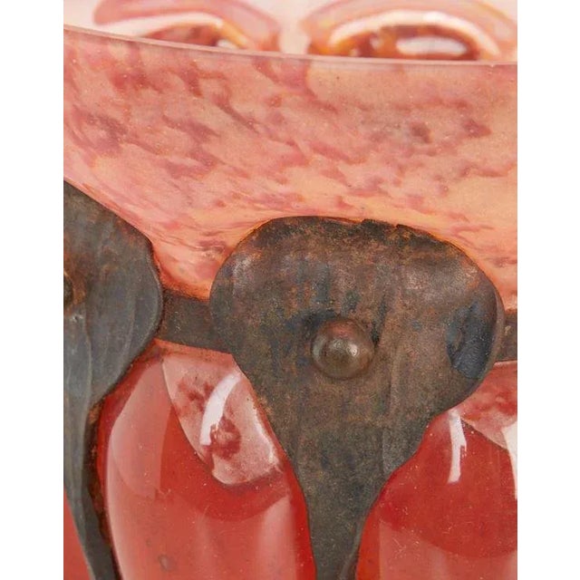 Early 20th century art deco vase with mottled orange, pink, and white glass body with wide flared rim and blown in a...