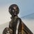 Art Deco wooden figure of a fashionable lady with a fur muff and long gown. Finely carved style icon in almost classic...